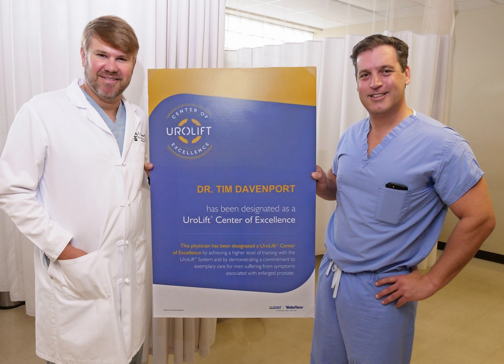 Doctor Timothy Davenport holding a purple and yellow Urolift award poster with Sean Deeney, Urology Consultant.